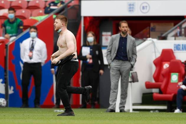 Middlesbrough, England, 6th June 2021. A pitch invader takes his short off during the International Friendly, Länderspiel, Nationalmannschaft match at the Riverside Stadium, Middlesbrough. Picture credit should read: Darren Staples Sportimage EDITORIAL USE ONLY. No use with unauthorised audio, video, data, fixture lists, club league logos or live services. Online in-match use limited to 120 images, no video emulation. No use in betting, games or single club league player publications. SPI-1079-0031
