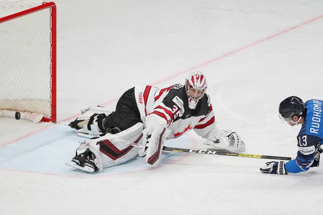 RIGA, LATVIA - JUNE 6, 2021: Finland s Mikael Ruohomaa (R) scores past Canadian goaltender Darcy Kuemper in their 2021 IIHF World Championship, WM, Weltmeisterschaft Final Ice hockey, Eishockey match at Arena Riga. Natalia Fedosenko TASS  TS103E75