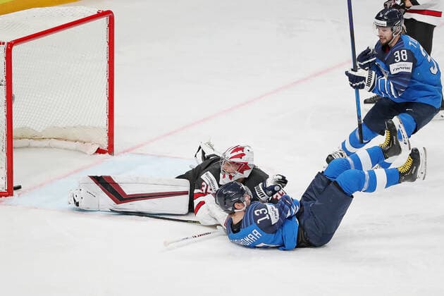 RIGA, LATVIA - JUNE 6, 2021: Finland s Mikael Ruohomaa (front) scores past Canadian goaltender Darcy Kuemper (L) in their 2021 IIHF World Championship, WM, Weltmeisterschaft Final Ice hockey, Eishockey match at Arena Riga. Natalia Fedosenko TASS  TS103E76
