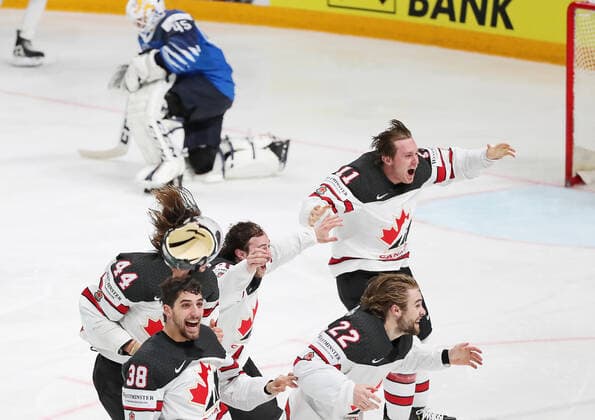 RIGA, LATVIA - JUNE 6, 2021: Canada s Mario Ferraro, Brandon Hagel (L-R front), Max Comtois, Andrew Mangiapane and Jaret Anderson-Dolan (L-R back) celebrate victory over Finland in their 2021 IIHF World Championship, WM, Weltmeisterschaft Final Ice hockey, Eishockey match at Arena Riga; Canada won 3-2 in overtime. Natalia Fedosenko TASS  TS103EB0