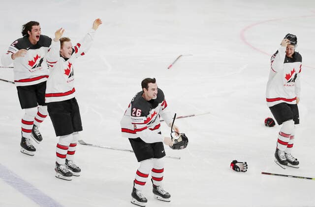 RIGA, LATVIA - JUNE 6, 2021: Canada s Braden Schneider, Jacob Bernard-Docker, Sean Walker and Gabriel Vilardi (L-R) celebrate victory over Finland in their 2021 IIHF World Championship, WM, Weltmeisterschaft Final Ice hockey, Eishockey match at Arena Riga; Canada won 3-2 in overtime. Natalia Fedosenko TASS  TS103EB1