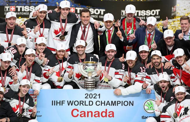RIGA, LATVIA - JUNE 6, 2021: Canadian players pose with their trophy as they celebrate victory over Finland in their 2021 IIHF World Championship, WM, Weltmeisterschaft Final Ice hockey, Eishockey match at Arena Riga; Canada won 3-2 in overtime. Natalia Fedosenko TASS  TS103EBA
