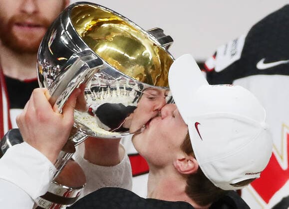 RIGA, LATVIA - JUNE 6, 2021: A Canadian player lays a kiss on their trophy as they celebrate victory over Finland in their 2021 IIHF World Championship, WM, Weltmeisterschaft Final Ice hockey, Eishockey match at Arena Riga; Canada won 3-2 in overtime. Natalia Fedosenko TASS  TS103EBD