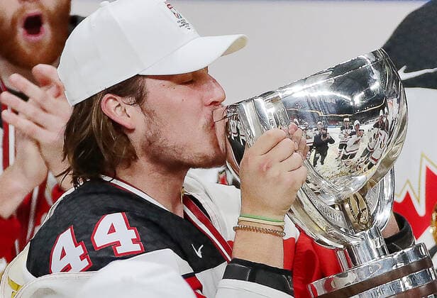 RIGA, LATVIA - JUNE 6, 2021: Canada s Max Comtois lays a kiss on their trophy as they celebrate victory over Finland in their 2021 IIHF World Championship, WM, Weltmeisterschaft Final Ice hockey, Eishockey match at Arena Riga; Canada won 3-2 in overtime. Natalia Fedosenko TASS  TS103ECA