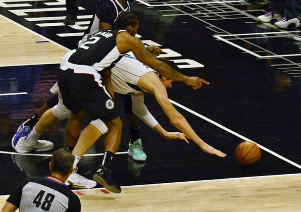 Dallas Mavericks center Boban Marjanovic (51) loses the ball out of bounds under pressure from Los Angeles Clippers forward Kawhi Leonard (2) during the first half of Game 7 of their first-round playoff series matchup at Staples Center in Los Angeles on June 6, 2021. The Clippers defeated the Mavericks 126-111. They advance to face the top-seeded Jazz starting Tuesday in Utah.  LAP2021060619 JIMxRUYMEN