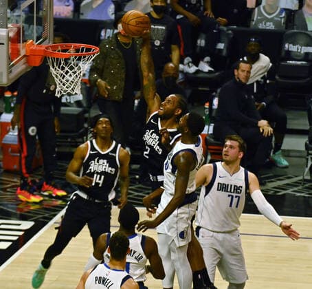 Los Angeles Clippers forward Kawhi Leonard (2) scores on three Dallas Mavericks defenders during the first half of Game 7 of their first-round playoff series matchup at Staples Center in Los Angeles on June 6, 2021. The Clippers defeated the Mavericks 126-111. They advance to face the top-seeded Jazz starting Tuesday in Utah.  LAP2021060633 JIMxRUYMEN