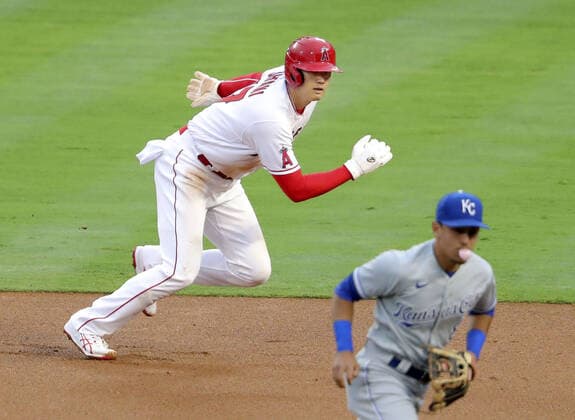 Baseball: Royals vs. Angels Shohei Ohtani (L) of the Los Angeles Angels runs as Anthony Rendon singles to left field in the first inning of a game against the Kansas City Royals on June 7, 2021, at Angel Stadium in Anaheim, California. 