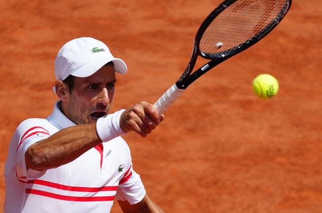 (210608) -- PARIS, June 8, 2021 -- Novak Djokovic of Serbia hits a return during the men s singles fourth round match between Novak Djokovic of Serbia and Lorenzo Musetti of Italy at the French Open tennis tournament at Roland Garros in Paris, France, June 7, 2021. ) (SP)FRANCE-PARIS-TENNIS-ROLAND GARROS-FRENCH OPEN-DAY 9 GaoxJing 