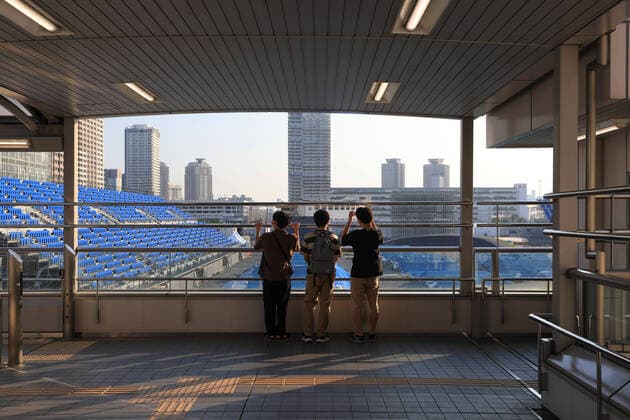 June 10, 2021, Tokyo, Japan: Three boys look at the Ariake Urban Sports Park from Ariake-tennis-no-mori subway station. .The venue will host the BMX and Skateboarding events at the Tokyo 2020 Olympics. Tokyo Japan - ZUMAs197 0121084445st Copyright: xStanislavxKogikux