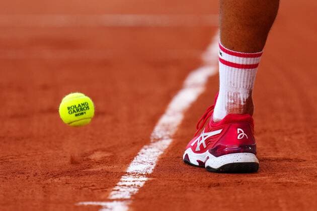 Mandatory Credit: Photo by Javier Garcia BPI Shutterstock (12058128io) The Asics tennis shoes of Novak Djokovic French Open Tennis, Day Thirteen, Roland Garros, Paris, France - 11 Jun 2021 French Open Tennis, Day Thirteen, Roland Garros, Paris, France - 11 Jun 2021  Copyright: xJavierxGarcia BPI Shutterstockx 12058128io