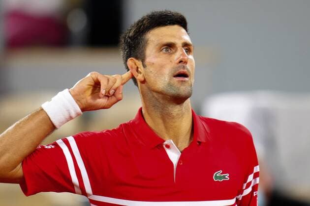 Mandatory Credit: Photo by Javier Garcia BPI Shutterstock (12058128ns) Novak Djokovic puts his finger to his ear during his semi final match French Open Tennis, Day Thirteen, Roland Garros, Paris, France - 11 Jun 2021 French Open Tennis, Day Thirteen, Roland Garros, Paris, France - 11 Jun 2021  Copyright: xJavierxGarcia BPI Shutterstockx 12058128ns