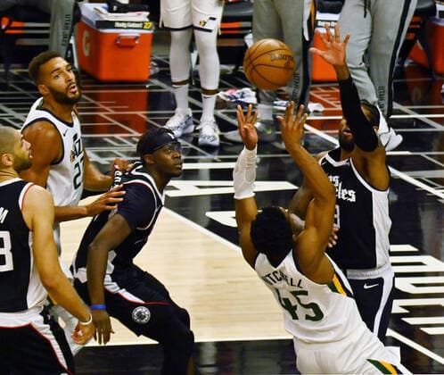 Utah Jazz guard Donovan Mitchell (45) loses control of the ball under pressure from Los Angeles Clippers guard Paul George (13) during the second half of Game 3 of the Western Conference second-round playoffs at Staples Center in Los Angeles on Saturday, June 12, 2021. The Clippers rallied to win another game 3, a 132-106 win over the Utah Jazz that cuts their deficit in this second-round series to 2-1 entering Monday s fourth game.  LAP2021061216 JIMxRUYMEN