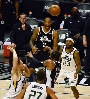 Los Angeles Clippers guard Paul George (13) passes the ball to forward Kawhi Leonard (2) under pressure from Utah Jazz defenders during the second half of Game 3 of the Western Conference second-round playoffs at Staples Center in Los Angeles on Saturday, June 12, 2021. The Clippers rallied to win another game 3, a 132-106 win over the Utah Jazz that cuts their deficit in this second-round series to 2-1 entering Monday s fourth game.  LAP2021061217 JIMxRUYMEN