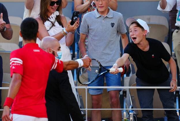 Mandatory Credit: Photo by Javier Garcia BPI Shutterstock (12058233ih) Novak Djokovic hands his racquet to an excited young fan after winning the Men s Singles final French Open Tennis, Day Fifteen, Roland Garros, Paris, France - 13 Jun 2021 French Open Tennis, Day Fifteen, Roland Garros, Paris, France - 13 Jun 2021  Copyright: xJavierxGarcia BPI Shutterstockx 12058233ih