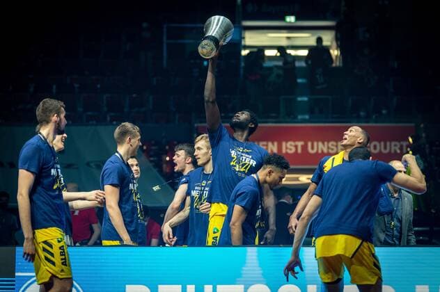 Basketball Munich 13 06 2021 1 Bundesliga easyCredit BBL Season 2020 2021 Playoffs Final Game 4 FC Bayern Munich Alba Berlin Alba wins the series with 3 1 and is German Champion 2021 Christ Koumadje Alba Berlin, No 21 with trophy and other