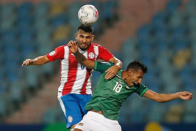 (210615) -- GOIANIA, June 15, 2021 -- Paraguay s Junior Alonso (L) vies with Bolivia s Gilbert Alvarez during the 2021 Copa America group A football match between Paraguay and Bolivia in Goiania, Brazil, on June 14, 2021. ) (SP)BRAZIL-GOIANIA-FOOTBALL-COPA AMERICA-PARAGUAY VS BOLIVIA LucioxTavora 