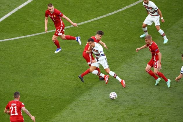 BUDAPEST, HUNGARY - JUNE 15: Cristiano Ronaldo (C)(7) from Portugal runs through Hungarian defense during the match at the UEFA EURO, EM, Europameisterschaft,Fussball 2020 Championship Group F match between Hungary and Portugal on June 15, 2021 in Budapest, Hungary. SPO, SOC, FOI 