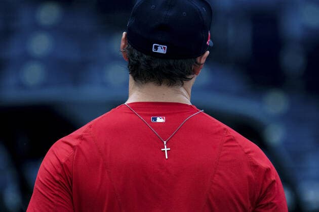 A Boston Red Sox players necklace ends up on his back after taking batting practice before the game against the Kansas City Royals at Kaufman Stadium in Kansas City, Missouri on Friday, June 18, 2021.  KCP20210618101 KYLExRIVAS