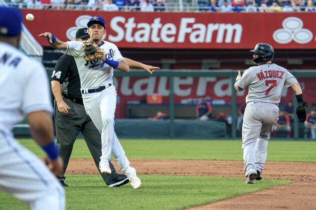 Kansas City Royals second baseman Nicky Lopez (8) tags out Boston Red Sox catcher Christian Vazquez (7) and throws out the runner at first for a double play in the second inning at Kaufman Stadium in Kansas City, Missouri on Friday, June 18, 2021.  KCP20210618111 KYLExRIVAS