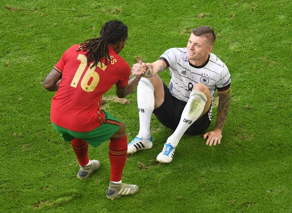 European Championship 2020 Portugal Germany 19 06 2021 in Munich Renato Sanches port helps Toni Kroos Deut to his feet DFL REGULATES PROHIBIT ANY USE OF PHOTOGRAPHS AS IMAGE SEQUENCES AND OR QUASI VIDEO HM