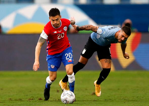 CUIABA, BRAZIL - JUNE 21: Charles Aranguiz of Chile competes for the ball with Giorgian De Arrascaeta of Uruguay ,during the match between Uruguay and Chile as part of Conmebol Copa America Brazil 2021 at Arena Pantanal on June 21, 2021 in Cuiaba, Brazil. SPO, SOC, ICH 