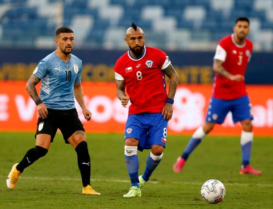 CUIABA, BRAZIL - JUNE 21: Arturo Vidal of Chile competes for the ball with Giorgian De Arrascaeta of Uruguay ,during the match between Uruguay and Chile as part of Conmebol Copa America Brazil 2021 at Arena Pantanal on June 21, 2021 in Cuiaba, Brazil. SPO, SOC, ICH 