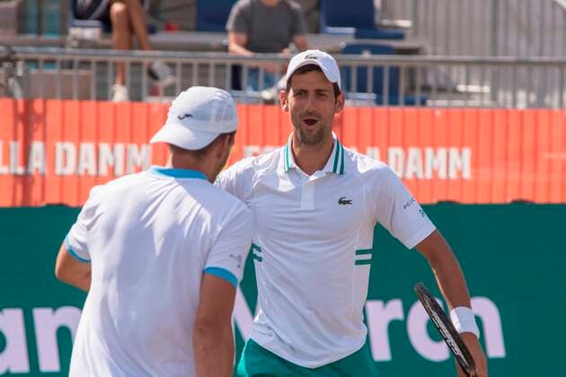 Serbian tennis player Novak Djokovic (R) and teammate Carlos Gomez-Herrera of Spain (L) react against Tomislav Brkic of Bosnia and Nikola Cacic of Serbia, during their Mallorca Championships ATP, Tennis Herren 250 tennis tournament s double match held at Mallorca Country Club in Santa Ponca, Mallorca, Balearic islands, Spain, 22 June 2021. Mallorca Championships ATP 250 tennis tournament !ACHTUNG: NUR REDAKTIONELLE NUTZUNG!  Copyright: xATIENZAx GRAF5808 20210622-f66f1c0376acf27941cb74205f8bc71b8f782dbd