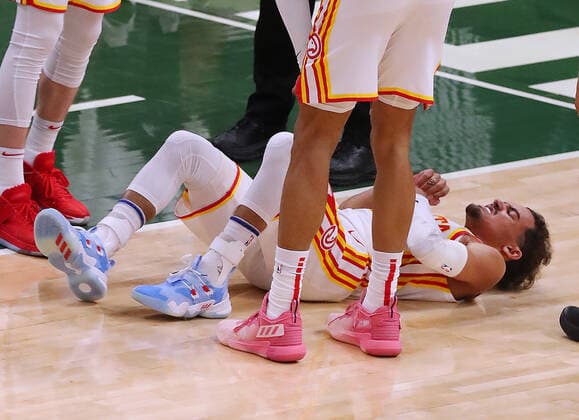 June 23, 2021, Milwaukee, WI, USA: The Atlanta Hawks Trae Young lays on the hardwood after drawing a hard foul against the Milwaukee Bucks during the second quarter in Game 1 of the NBA, Basketball Herren, USA Eastern Conference Finals on Wednesday, June 23, 2021, at the Fiserv Forum in Milwaukee. The Hawks won, 116-113. Milwaukee USA - ZUMAm67_ 0122638560st Copyright: xCurtisxComptonx