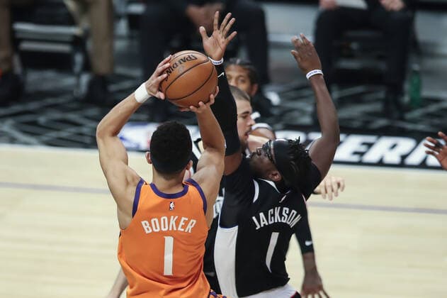 LOS ANGELES, CA - JUNE 24: Phoenix Suns guard Devin Booker (1) goes up against LA Clippers guard Reggie Jackson (1) during the Phoenix Suns game versus the Los Angeles Clippers game 3 NBA, Basketball Herren, USA Western Conference Finals game on June 24, 2021, at Staples Center in Los Angeles, CA. (Photo by Jevone Moore Icon Sportswire) NBA: JUN 24 Western Conference Final - Suns at Clippers Icon210624036