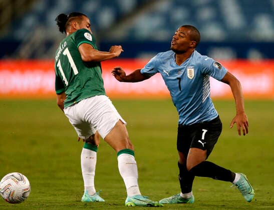 CUIABA, BRAZIL - JUNE 24: Nicolas De La Cruz of Uruguay competes for the ball with Rodrigo Luis Ramallo of Bolivia ,during the match between Bolivia and Uruguay as part of Conmebol Copa America Brazil 2021 at Arena Pantanal on June 24, 2021 in Cuiaba, Brazil. SPO, SOC, ICH 