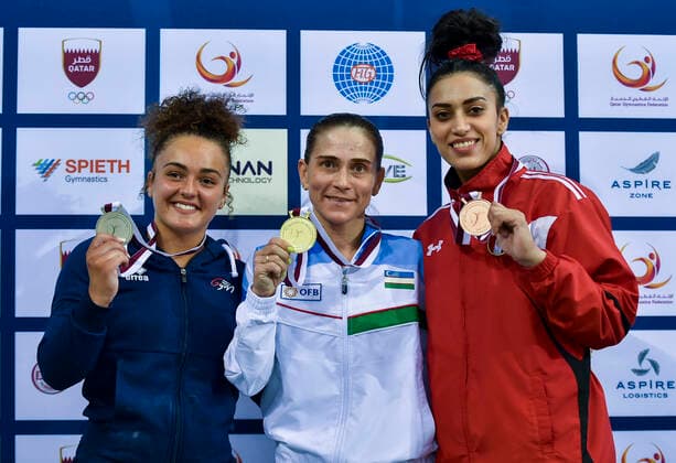 (210626) -- DOHA, June 26, 2021 -- Gold medalist Oksana Chusovitina (C) of Uzbekistan poses with silver medalist Coline Devillard (L) of France and bronze medalist Nancy Taman of Egypt during the awarding ceremony for the Women s Vault Final at the 13th FIG Artistic Gymnastics World Cup in Doha, capital of Qatar, on June 25, 2021. (Photo by Xinhua) (SP)QATAR-DOHA-GYMNASTICS-WORLD CUP Nikku 