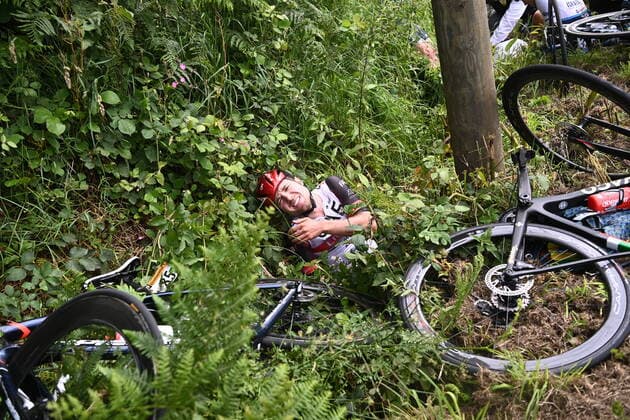 Swiss Mark Hirschi of UAE Team Emirates lies in a ditch on the side of the road after a fall during the first stage of the 108th edition of the Tour de France cycling race, 197,8km from Brest to Landerneau, France, . This year s Tour de France takes place from 26 June to 18 July 2021. POOLxANNE-CHRISTINExPOUJOULAT  x3019274x