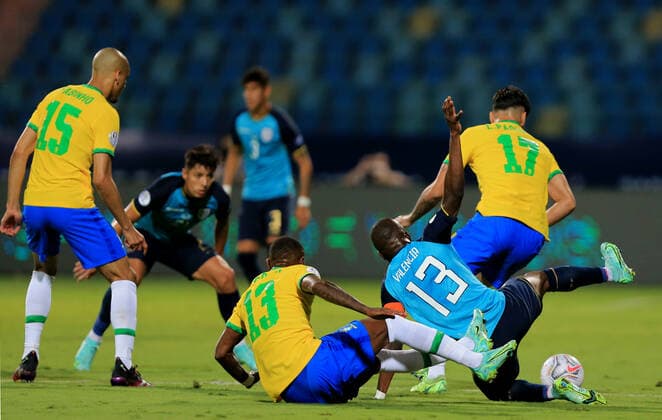 GOIANIA, BRAZIL - JUNE 27: Enner Valencia of Ecuador competes for the ball with Emerson and Lucas Paqueta of Brazil ,during the match between Brazil and Ecuador as part of Conmebol Copa America Brazil 2021 at Estadio Olimpico on June 27, 2021 in Goiania, Brazil. SPO, SOC 