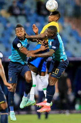 GOIANIA, BRAZIL - JUNE 27: Emerson of Brazil head the ball against Pervis Estupinan and Jhegson Mendez of Ecuador ,during the match between Brazil and Ecuador as part of Conmebol Copa America Brazil 2021 at Estadio Olimpico on June 27, 2021 in Goiania, Brazil. SPO, SOC 