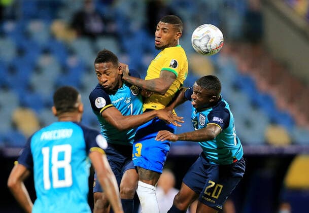 GOIANIA, BRAZIL - JUNE 27: Emerson of Brazil head the ball against Pervis Estupinan and Jhegson Mendez of Ecuador ,during the match between Brazil and Ecuador as part of Conmebol Copa America Brazil 2021 at Estadio Olimpico on June 27, 2021 in Goiania, Brazil. SPO, SOC 