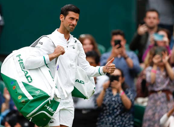 (210629) -- LONDON, June 29, 2021 -- Novak Djokovic of Serbia greets the spectators ahead of the men s singles first round match between Novak Djokovic of Serbia and Jack Draper of Great Britain at the 2021 Wimbledon Tennis Championships in London, Britain, on June 28, 2021. ) (SP)BRITAIN-LONDON-TENNIS-WIMBLEDON-DAY 1 HanxYan 