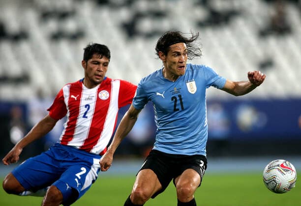 RIO DE JANEIRO, BRAZIL - JUNE 28: Edinson Cavani of Uruguay competes for the ball with Robert Rojas of Paraguay ,during the match between Uruguay and Paraguay as part of Conmebol Copa America Brazil 2021 at Estadio Olimpico Nilton Santos on June 28, 2021 in Rio de Janeiro, Brazil. SPO, SOC, ICH 