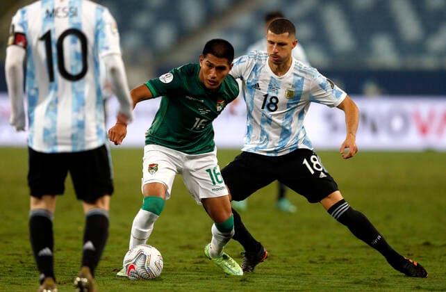CUIABA, BRAZIL - JUNE 28: Erwin Saavedra of Bolivia competes for the ball with Guido Rodriguez and Lionel Messi of Argentina ,during the match between Bolivia and Argentina as part of Conmebol Copa America Brazil 2021 at Estadio Arena Pantanal on June 28, 2021 in Cuiaba, Brazil. SPO, SOC, ICH 