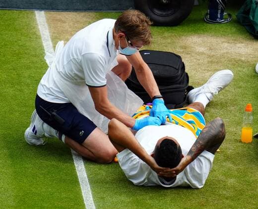 Mandatory Credit: Photo by Javier Garcia Shutterstock (12194408ct) Nick Kyrgios receives treatment during his third round match Wimbledon Tennis Championships, Day 6, The All England Lawn Tennis and Croquet Club, London, UK - 03 Jul 2021 Wimbledon Tennis Championships, Day 6, The All England Lawn Tennis and Croquet Club, London, UK - 03 Jul 2021  Copyright: xJavierxGarcia Shutterstockx 12194408ct