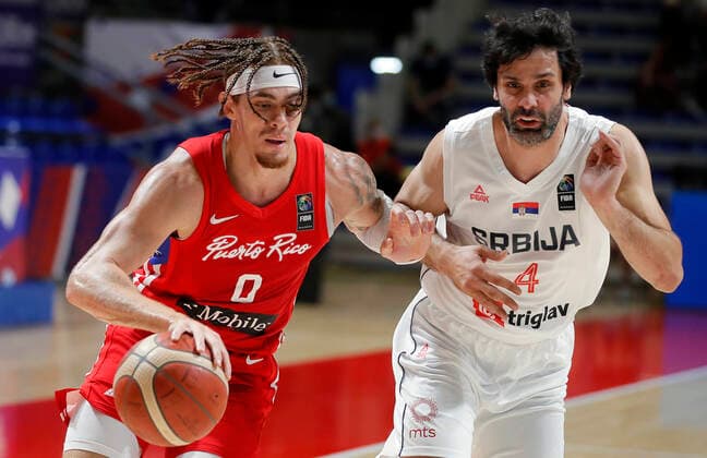 (210704) -- BELGRADE, July 4, 2021 -- Puerto Rico s Isaiah Pineiro (L) vies with Serbia s Milos Teodosic during FIBA Olympic Qualifying Tournament basketball semi-final match between Serbia and Puerto Rico in Belgrade, Serbia on July 3, 2021. (Photo by Xinhua) (SP)SERBIA-BELGRADE-BASKETBALL-FIBA OQT-SEMI-FINALS-SERBIA VS PUERTO RICO PredragxMilosavljevic 