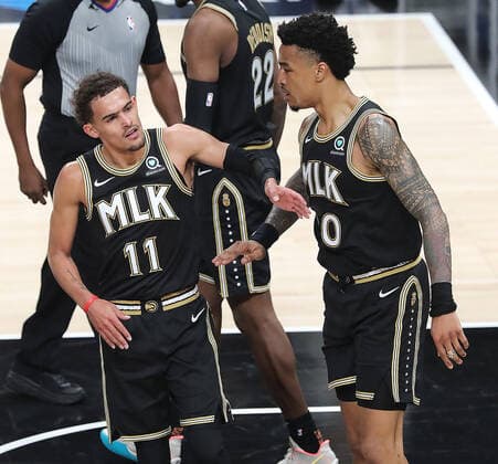 July 3, 2021, Atlanta, GA, USA: The Atlanta Hawks Trae Young (11) gives teammate John Collins a pat on the chest after he drew a foul against the Milwaukee Bucks in Game 6 of the Eastern Conference Finals on Saturday, July 3, 2021, at State Farm Arena in Atlanta. The Bucks advanced, 118-107. Atlanta USA - ZUMAm67_ 0124090255st Copyright: xCurtisxComptonx