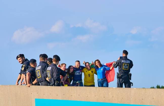 Policeman takes a picture of Italian and belgian fans in the quarterfinal match BELGIUM - ITALY 1-2 at the football UEFA European Championships 2020 in Season 2020 2021 on July 02, 2021 in Munich, Germany.