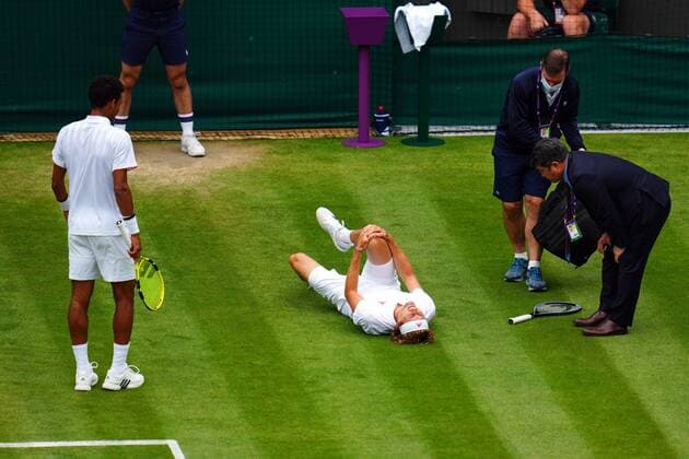 Mandatory Credit: Photo by Javier Garcia Shutterstock (12196117jt) Alexander Zverev oin the ground, injured, during his fourth round match against Felix Auger-Aliassime Wimbledon Tennis Championships, Day 7, The All England Lawn Tennis and Croquet Club, London, UK - 05 Jul 2021 Wimbledon Tennis Championships, Day 7, The All England Lawn Tennis and Croquet Club, London, UK - 05 Jul 2021 Copyright: xJavierxGarcia Shutterstockx 12196117jt