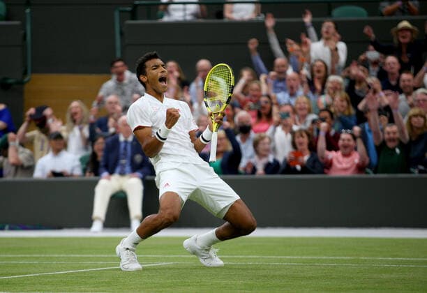 Mandatory Credit: Photo by Shutterstock (12196120ak) Felix Auger Aliassime of Canada celebrates on match point Wimbledon Tennis Championships, Day 7, The All England Lawn Tennis and Croquet Club, London, UK - 05 Jul 2021 Wimbledon Tennis Championships, Day 7, The All England Lawn Tennis and Croquet Club, London, UK - 05 Jul 2021  Copyright: xShutterstockx 12196120ak