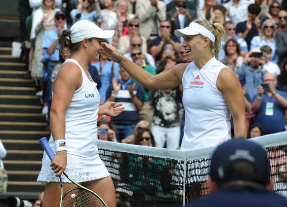 Sport Bilder des Tages Lawn Tennis - 2021 All England Championships - Week Two - Thursday - Wimbledon - Ladies Semi Final . Ashleigh Barty v Angelique Kerber Ashleigh Barty of Australia is congratulated by Angelique Kerber at the net after the match 