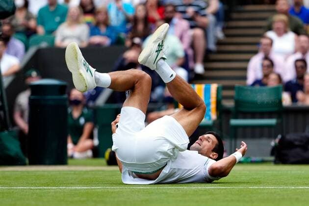 Mandatory Credit: Photo by Shutterstock (12202136cx) Novak Djokovic slipping over during his semi-final match Wimbledon Tennis Championships, Day 11, The All England Lawn Tennis and Croquet Club, London, UK - 09 Jul 2021 Wimbledon Tennis Championships, Day 11, The All England Lawn Tennis and Croquet Club, London, UK - 09 Jul 2021  Copyright: xShutterstockx 12202136cx