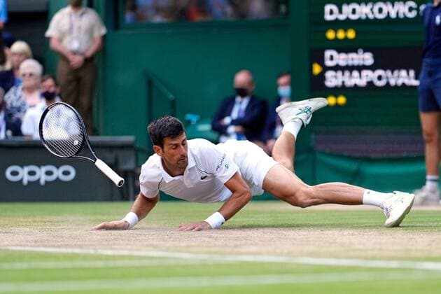 Mandatory Credit: Photo by Shutterstock (12202136du) Novak Djokovic slips over during his semi-final match Wimbledon Tennis Championships, Day 11, The All England Lawn Tennis and Croquet Club, London, UK - 09 Jul 2021 Wimbledon Tennis Championships, Day 11, The All England Lawn Tennis and Croquet Club, London, UK - 09 Jul 2021  Copyright: xShutterstockx 12202136du