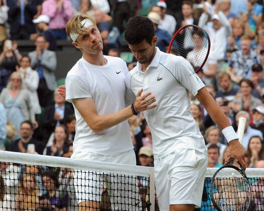 Lawn Tennis - 2021 All England Championships - Week Two - Friday - Wimbledon Mens Semi Final - Novak Djokovic v Denis Shapovalov Denis Shapovalov congratulates Novak Djokovic at the net after the match 
