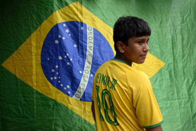 India: Brazil Football supporter support their team ahead of Copa America final in Kolkata A supporter of Brazil wearing Brazil football jersey standing next to a Brazil national flag and Neimar Junior poster ahead of Copa America Football final match between Brazil and Argentina in Kolkata. Kolkata West Bengal India Copyright: SudiptaxDas