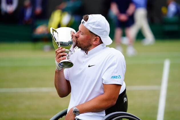Mandatory Credit: Photo by Javier Garcia Shutterstock (12203621bc) Dylan Alcott celebrates with the trophy after victory in the Quad Wheelchair Singles final Wimbledon Tennis Championships, Day 12, The All England Lawn Tennis and Croquet Club, London, UK - 10 Jul 2021 Wimbledon Tennis Championships, Day 12, The All England Lawn Tennis and Croquet Club, London, UK - 10 Jul 2021  Copyright: xJavierxGarcia Shutterstockx 12203621bc